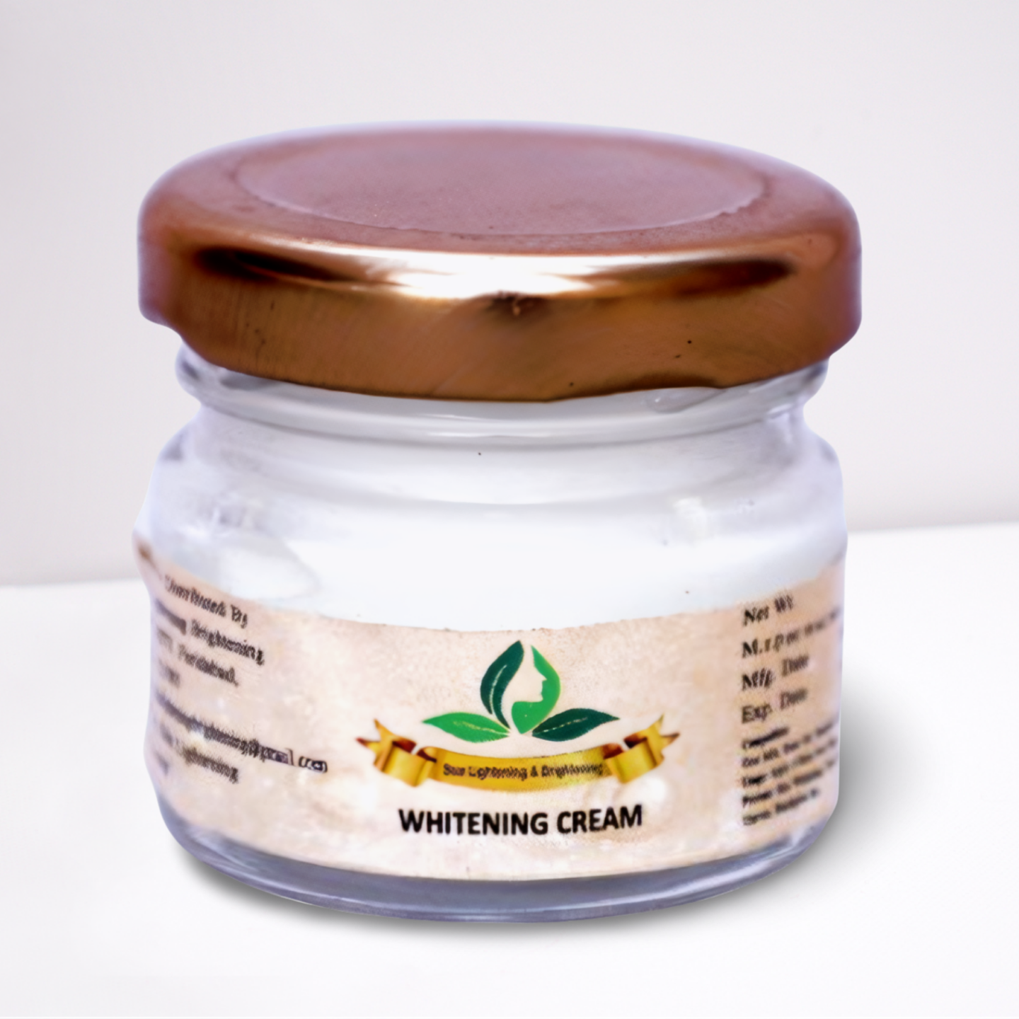 Small transparent glass jar with golden lid labeled Whitening Cream from Skin Lightening & Brightening brand.